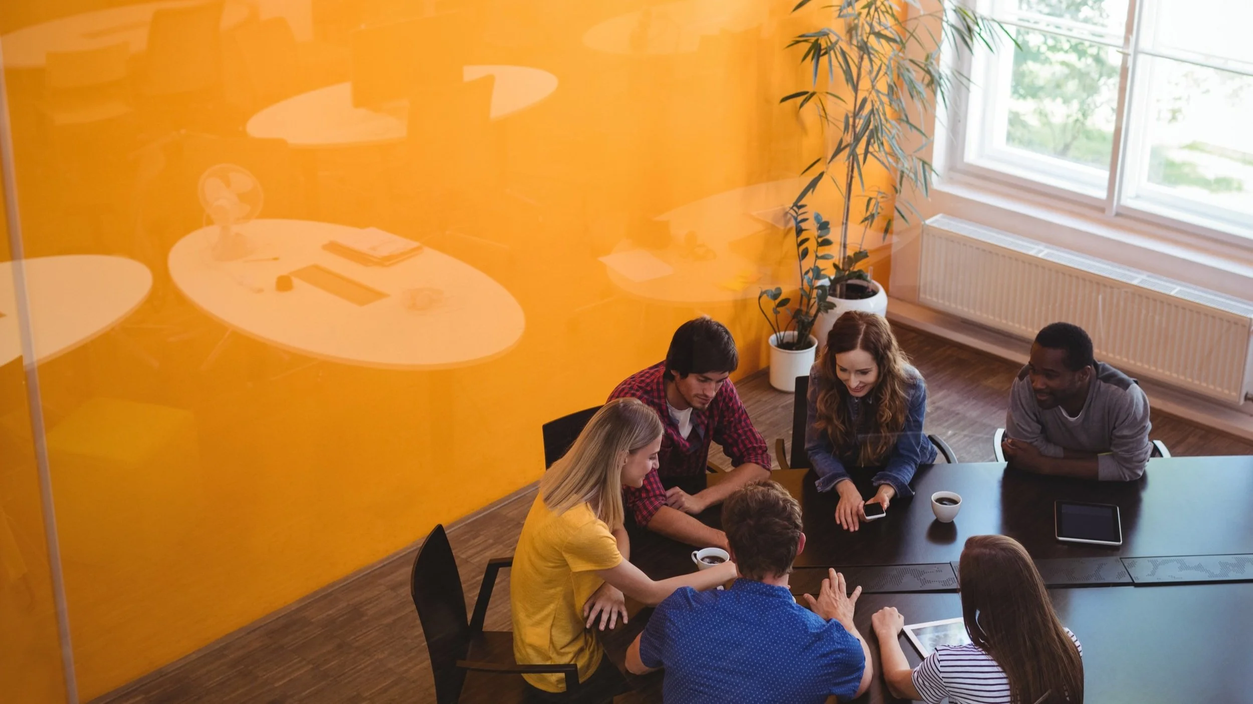 A team collaborating around a table in a flexible workspace